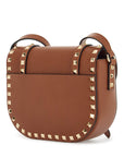 Valentino Garavani small messenger crossbody bag in brown hammered leather with studs